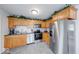Kitchen with stainless steel appliances and oak cabinets; offers a clean and modern space at 517 S 4Th Ave, Beech Grove, IN 46107