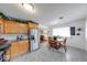 Bright eat-in kitchen features stainless steel refrigerator, granite counters, and oak cabinets at 517 S 4Th Ave, Beech Grove, IN 46107
