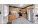 Well-lit kitchen with stainless steel appliances and oak cabinets, with a clean aesthetic at 517 S 4Th Ave, Beech Grove, IN 46107