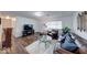 Cozy living room with hardwood floors, a leather sofa, and a bright window at 517 S 4Th Ave, Beech Grove, IN 46107