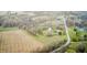 Aerial shot showcases a home nestled among a mix of farmland, trees, and a nearby pond at 5320 S Lick Crk Rd, Morgantown, IN 46160