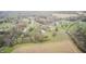 Picturesque aerial view of a home surrounded by farmland, trees, a pond, and a quiet road at 5320 S Lick Crk Rd, Morgantown, IN 46160