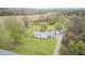 Aerial shot showcases a quaint house nestled amidst verdant trees and a country road at 5320 S Lick Crk Rd, Morgantown, IN 46160