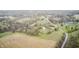 A high-angle view shows a house surrounded by lush greenery, fields, ponds, and a winding road at 5320 S Lick Crk Rd, Morgantown, IN 46160