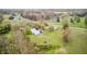 Aerial view featuring a barn and charming outbuildings on a well-maintained property with mature trees at 5320 S Lick Crk Rd, Morgantown, IN 46160