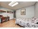 Neutral bedroom with a bed, desk, wood floors, and bright lighting at 5320 S Lick Crk Rd, Morgantown, IN 46160