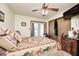Inviting bedroom with unique horse patterned bedding, a ceiling fan, and ample natural light, designed for comfort at 5320 S Lick Crk Rd, Morgantown, IN 46160
