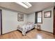 Simple bedroom with neutral walls, wood-look flooring, and a twin bed, offering a calm and restful retreat at 5320 S Lick Crk Rd, Morgantown, IN 46160