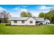 Exterior view of a charming single-story home featuring a metal roof and inviting front porch at 5320 S Lick Crk Rd, Morgantown, IN 46160