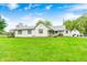Quaint single story home with white siding and a large, lush front yard perfect for outdoor activities at 5320 S Lick Crk Rd, Morgantown, IN 46160