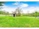 View of a small wooden shed in a grassy field under a partly cloudy sky at 5320 S Lick Crk Rd, Morgantown, IN 46160