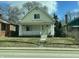 Welcoming home featuring a classic front porch with white columns and railings, complemented by a neat lawn and a clear sky at 537 N Rural St, Indianapolis, IN 46201