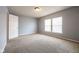 Bright bedroom with neutral carpet, light blue walls, and two windows at 5422 Portman Dr, Noblesville, IN 46062