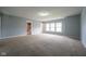 Large bedroom with neutral carpet, light-blue walls, and view to bathroom at 5422 Portman Dr, Noblesville, IN 46062
