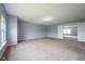 Bright bedroom featuring neutral carpet, light-blue walls, and an open doorway at 5422 Portman Dr, Noblesville, IN 46062