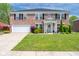 Charming two-story brick home featuring a well-manicured lawn and welcoming front porch at 5422 Portman Dr, Noblesville, IN 46062