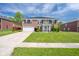Traditional brick home with attached garage and landscaped front yard at 5422 Portman Dr, Noblesville, IN 46062