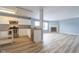Bright kitchen featuring stainless steel appliances and ample cabinet space flowing into a spacious living area with fireplace at 5422 Portman Dr, Noblesville, IN 46062
