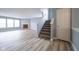 Open-concept living area with a staircase, fireplace, and plenty of natural light at 5422 Portman Dr, Noblesville, IN 46062