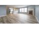 Spacious living area featuring wood floors and a fireplace, connecting to an open kitchen area at 5422 Portman Dr, Noblesville, IN 46062