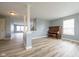 Open living room showcasing decorative columns, neutral walls, and hard surface floors at 5422 Portman Dr, Noblesville, IN 46062