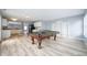 Living room with an open-concept design, featuring a pool table, and a view to the kitchen at 5422 Portman Dr, Noblesville, IN 46062
