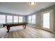 Living room featuring a pool table, wood floors, and plenty of natural light at 5422 Portman Dr, Noblesville, IN 46062