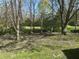 Backyard with bright green grass, mature trees, and shade at 5822 W 62Nd St, Indianapolis, IN 46278