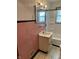 Bathroom with pink tile, a sink, toilet, and shower at 5822 W 62Nd St, Indianapolis, IN 46278