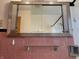 Close up of a medicine cabinet and pink tiled walls in a bathroom at 5822 W 62Nd St, Indianapolis, IN 46278