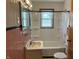 Bathroom with a sink, toilet, shower, and pink tile at 5822 W 62Nd St, Indianapolis, IN 46278