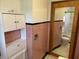 Bathroom with pink tile, cabinets, sink, toilet, and shower at 5822 W 62Nd St, Indianapolis, IN 46278