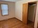 A cozy bedroom with hardwood floors and a closet at 5822 W 62Nd St, Indianapolis, IN 46278