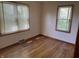 An empty bedroom with hardwood floors and two windows at 5822 W 62Nd St, Indianapolis, IN 46278
