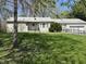 Charming ranch-style home featuring a well-maintained lawn and accessible ramp at 5822 W 62Nd St, Indianapolis, IN 46278
