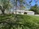 Charming ranch-style home featuring a well-maintained lawn and accessible ramp at 5822 W 62Nd St, Indianapolis, IN 46278