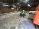 Spacious garage featuring exposed wood framework and a ride on lawnmower at 5822 W 62Nd St, Indianapolis, IN 46278