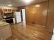 Spacious kitchen with stainless steel appliances, wood paneled walls, and wood floors at 5822 W 62Nd St, Indianapolis, IN 46278