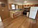 Well-lit kitchen with stainless steel appliances, wood floors, and plenty of cabinet space at 5822 W 62Nd St, Indianapolis, IN 46278