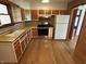 Modern kitchen with stainless steel appliances, ample counter space, and wood flooring at 5822 W 62Nd St, Indianapolis, IN 46278