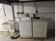 A well-equipped laundry area with washer, dryer, and utility sink, ideal for chores at 5822 W 62Nd St, Indianapolis, IN 46278