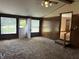 Sun-filled living room with bright windows, exterior door, and wood paneling at 5822 W 62Nd St, Indianapolis, IN 46278