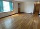 Spacious living room featuring hardwood floors and ample natural light from large windows at 5822 W 62Nd St, Indianapolis, IN 46278