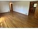 Inviting living room with gleaming hardwood floors and a doorway view into the kitchen at 5822 W 62Nd St, Indianapolis, IN 46278