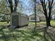 Exterior of shed with double doors, featuring home in the background, surrounded by trees at 5822 W 62Nd St, Indianapolis, IN 46278