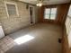 Sunroom featuring tile and carpet flooring, wood paneling and updated windows at 5822 W 62Nd St, Indianapolis, IN 46278
