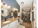 Bright bathroom featuring a double vanity, granite countertops, and a glass-enclosed shower at 5982 Blue Heron Way, Plainfield, IN 46168