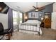 Comfortable primary bedroom featuring a ceiling fan, gray accent wall, and plush carpet at 5982 Blue Heron Way, Plainfield, IN 46168