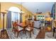 Cozy dining area with a wooden table, chandelier, and views into the living room at 5982 Blue Heron Way, Plainfield, IN 46168