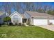 Charming home featuring an attached garage, well-maintained lawn, and lush landscaping at 5982 Blue Heron Way, Plainfield, IN 46168